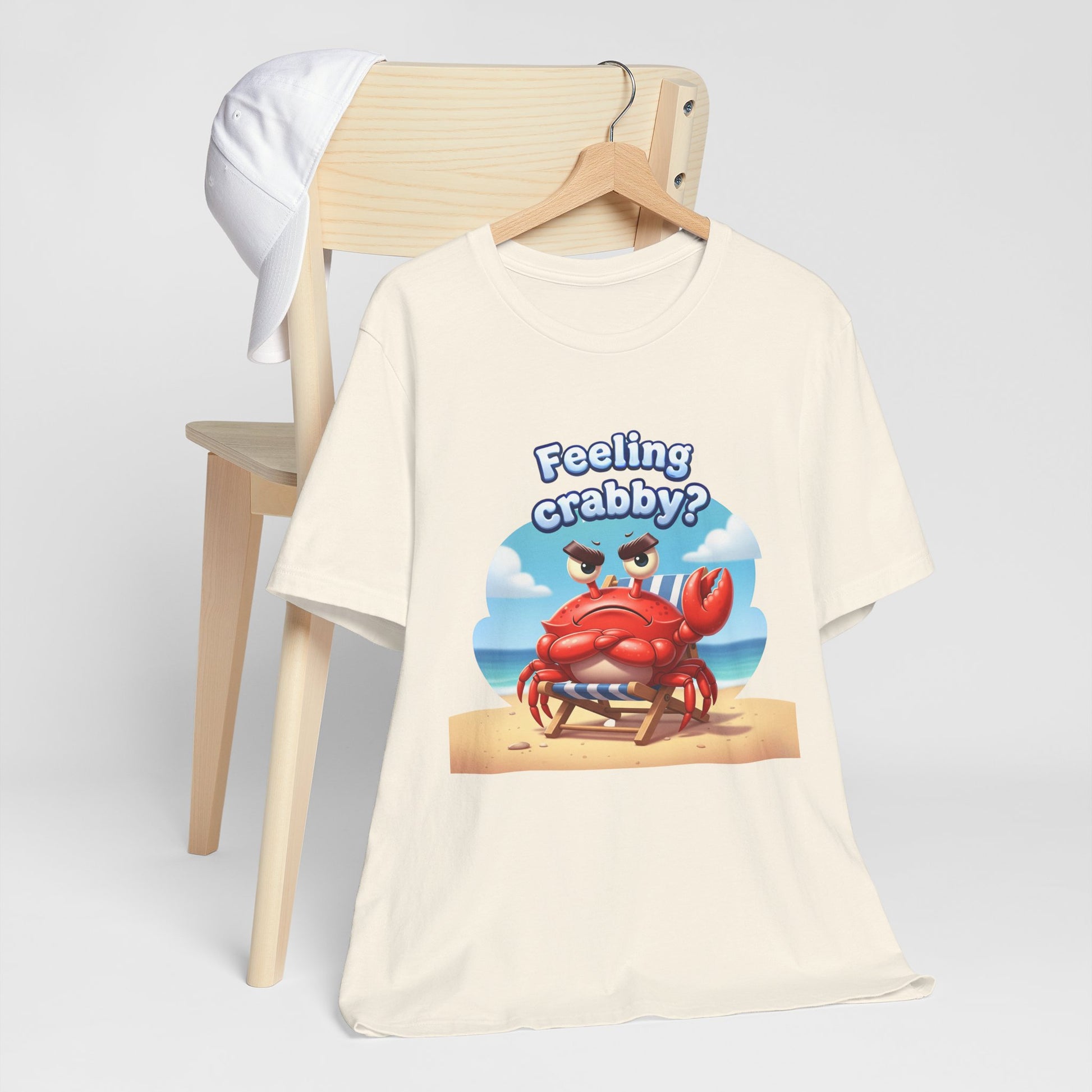 Beige t-shirt with a cartoon crab graphic and text 'Feeling crabby?' on a white background.