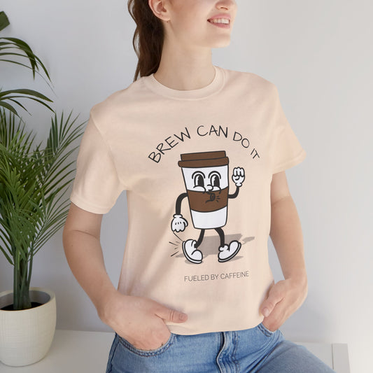 Person wearing a t-shirt with a cartoon coffee cup design and text 'Brew Can Do It Fueled By Caffeine'.