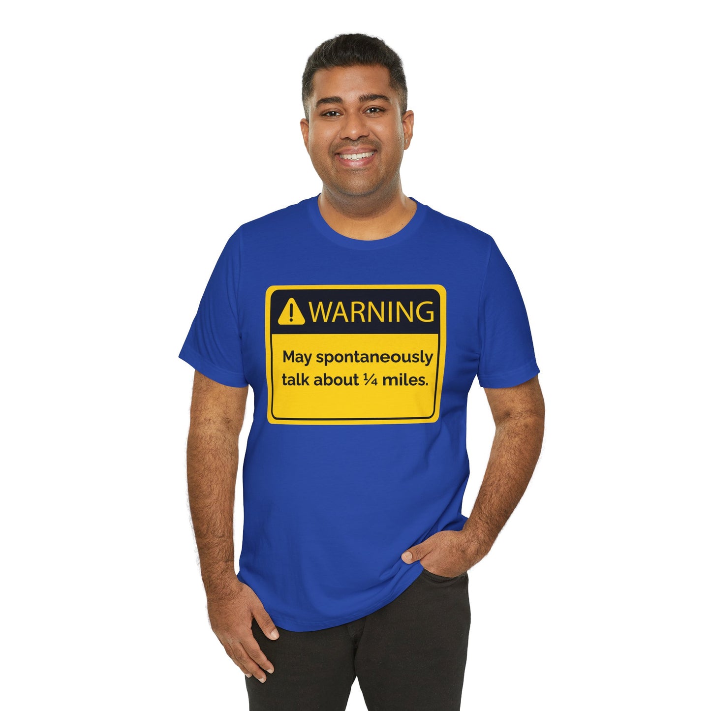 Man wearing a blue t-shirt with a yellow warning sign 'WARNING May spontaneously talk about 1/4 miles' graphic on a white background