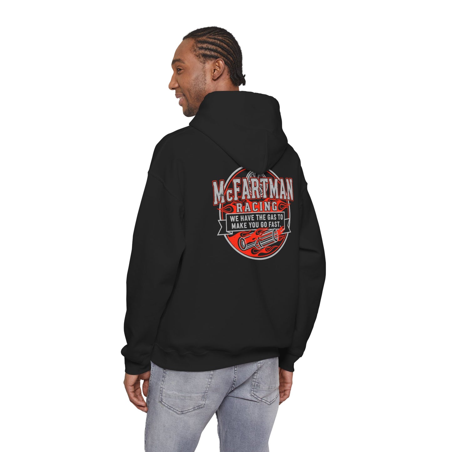 Person wearing a black hoodie with a graphic design McFartman Racing We have the gas to make you go fast on the back, standing against a white background