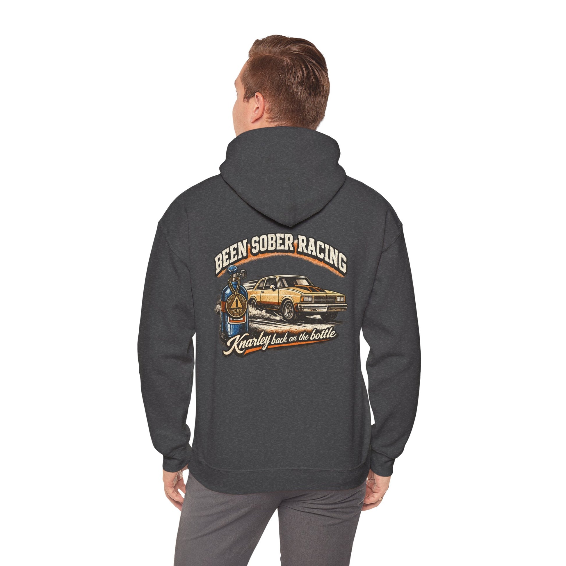 Person wearing a hoodie with a graphic design on the back, featuring 'Been Sober Racing Knarley back on the bottle' text and a car illustration.
