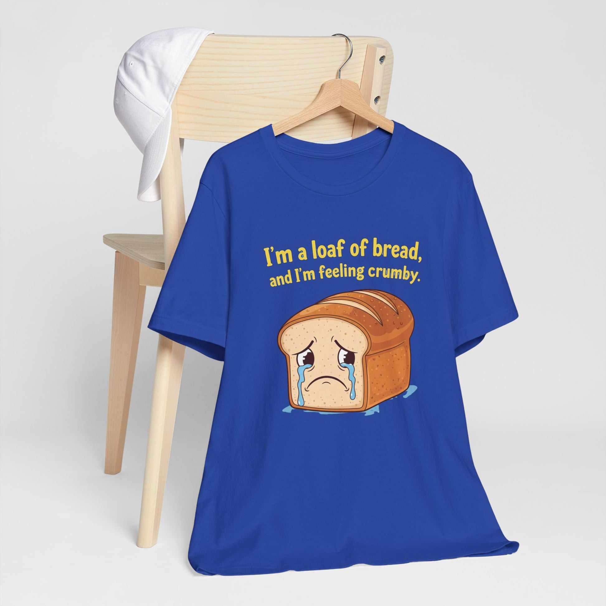 Blue t-shirt with bread graphic and text on a white background. Text says, 'I'm a loaf of bread, and I'm feeling crumby'