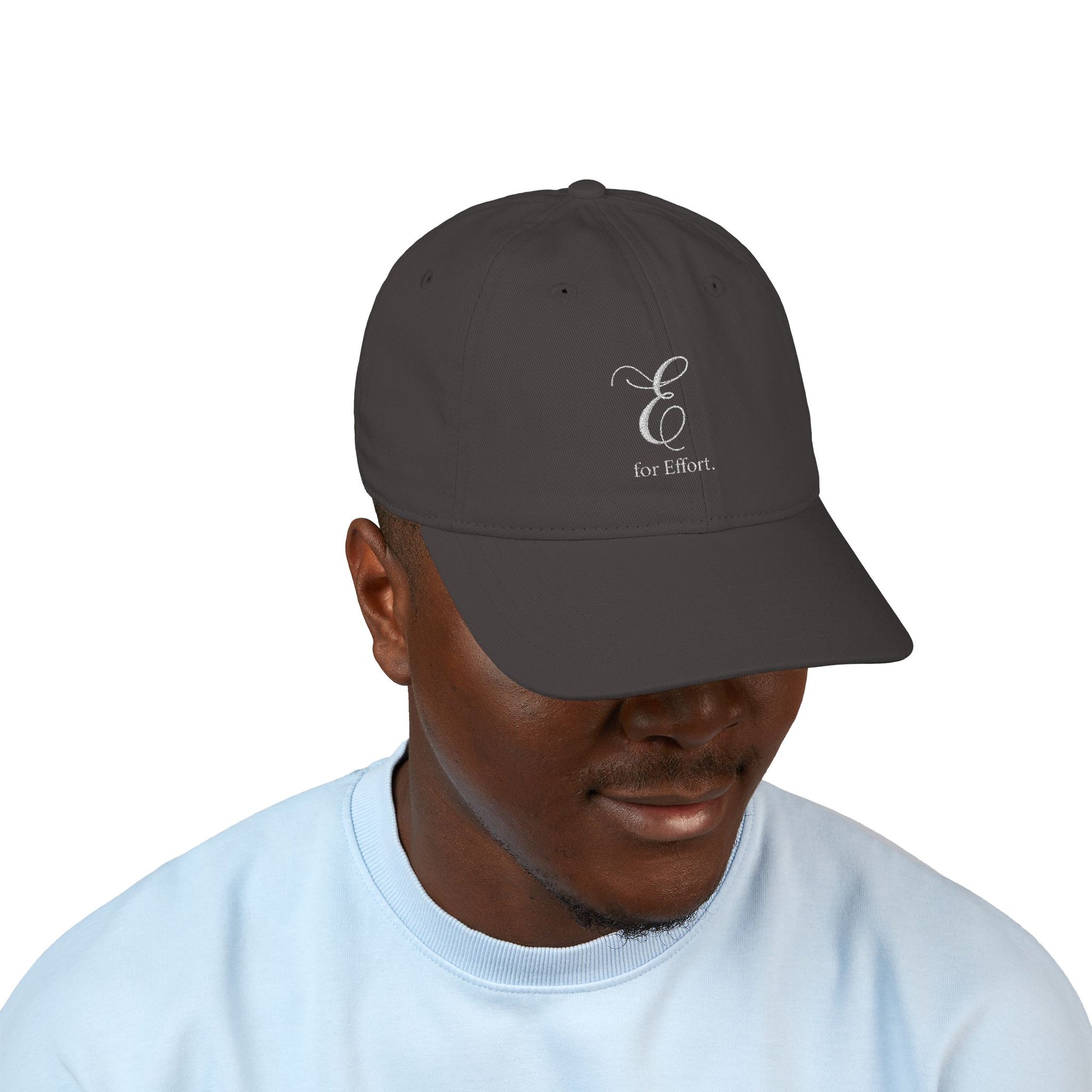 Person wearing a dark gray cap with a logo and text 'E for Effort' on a white background