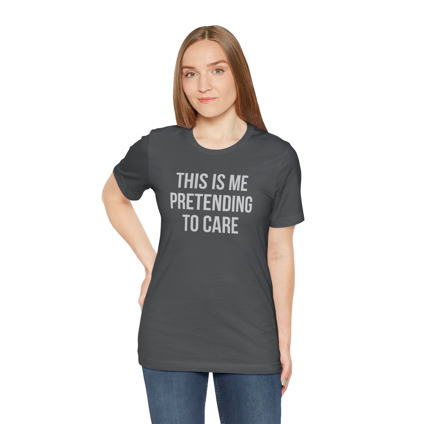 Woman wearing a dark gray t-shirt with text 'This is me pretending to care' on a white background