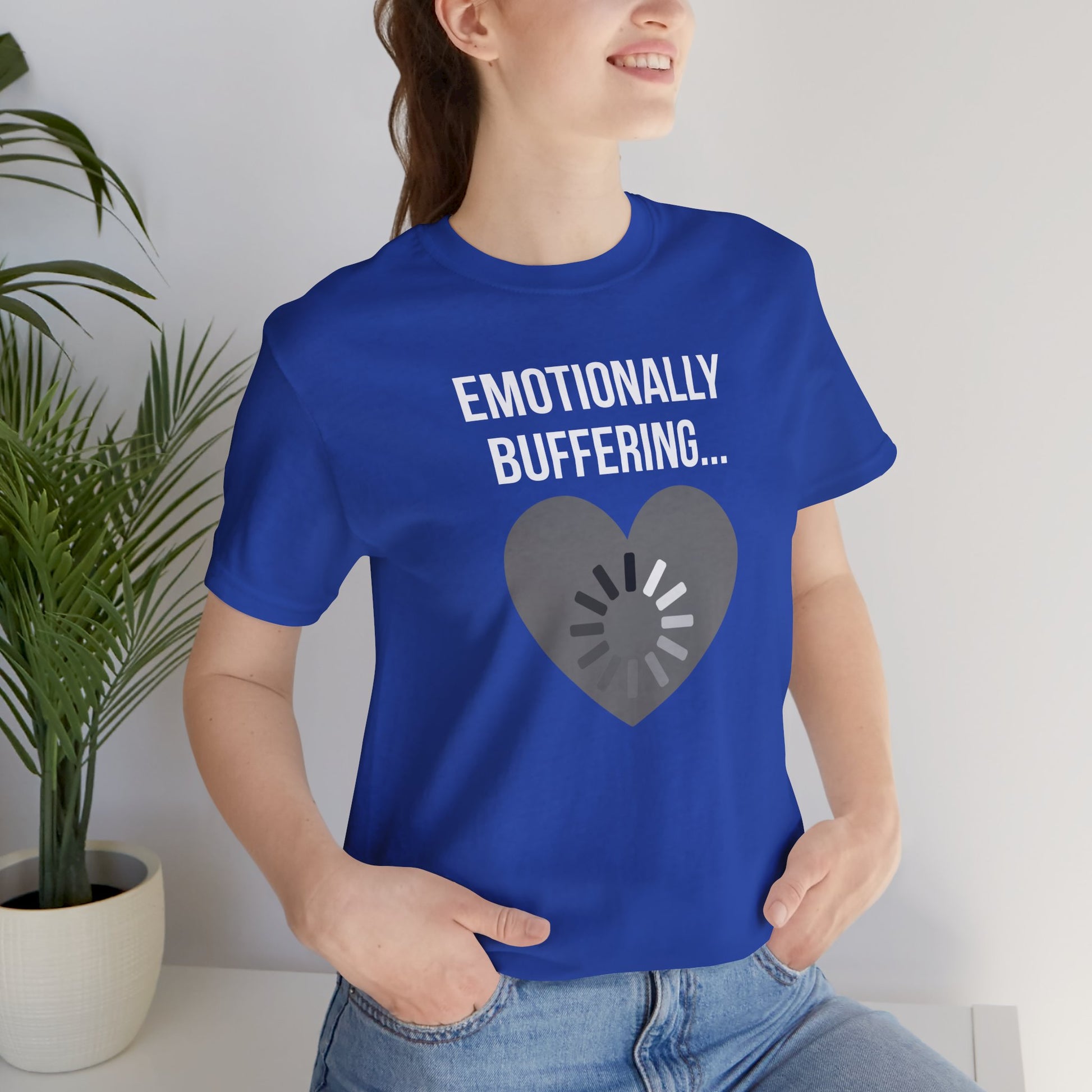 Person wearing a blue t-shirt with 'Emotionally Buffering...' text and heart design.