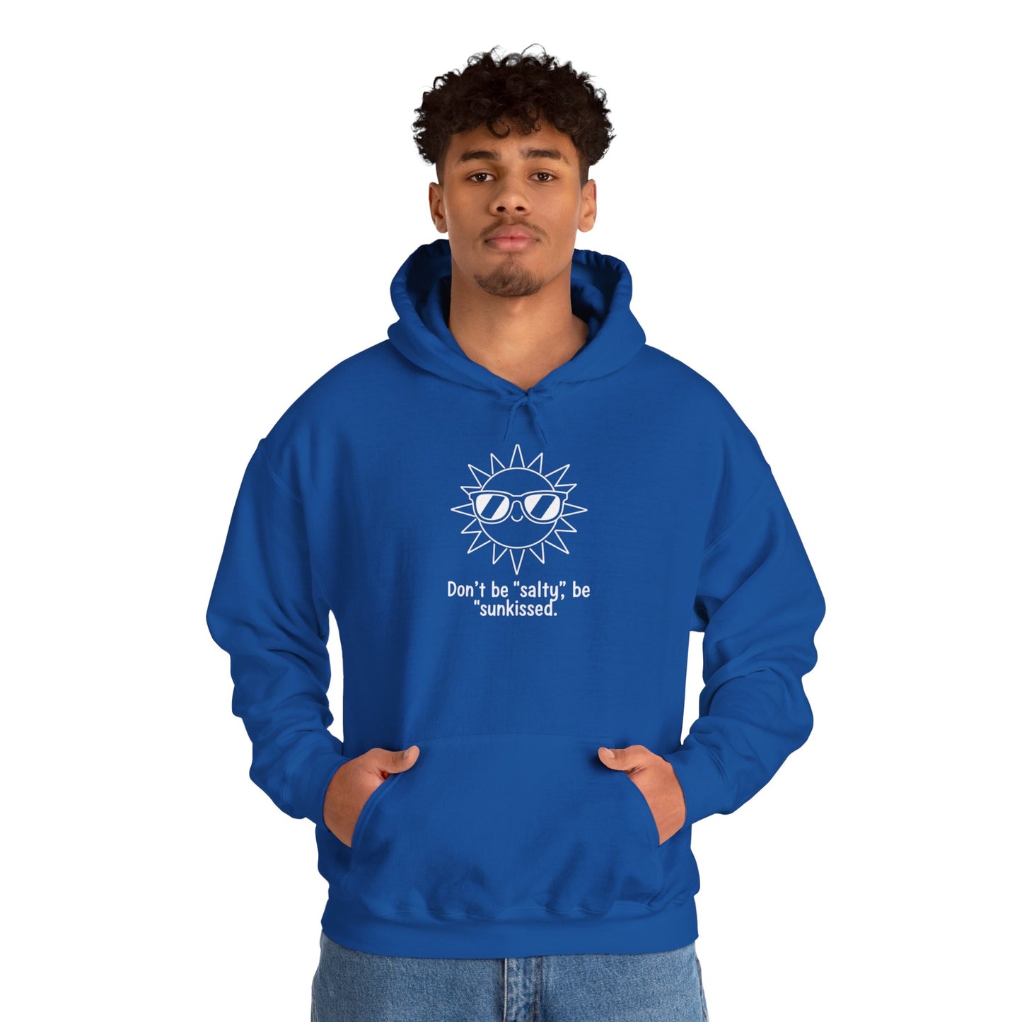 Person wearing a blue hoodie with a sun graphic and text 'Don't be salty, be sunkissed' on a white background