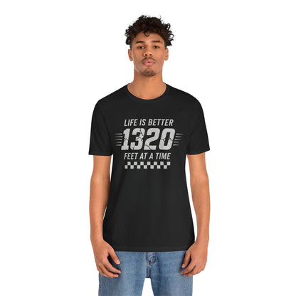 Person wearing a black t-shirt with text 'Life is better 1320 feet at a time' on a white background