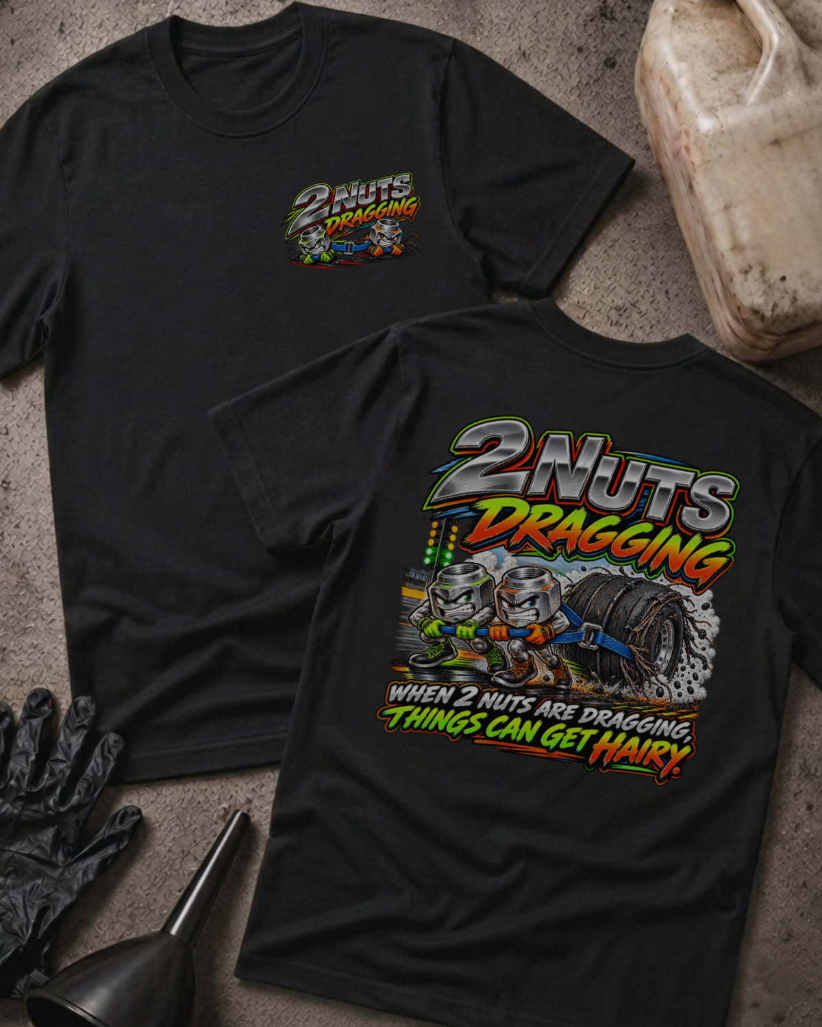 Black 2 Nuts Dragging T-shirt, front and back views with cartoon nuts pulling a racing tire and the slogan “When 2 nuts are dragging, things can get hairy.”