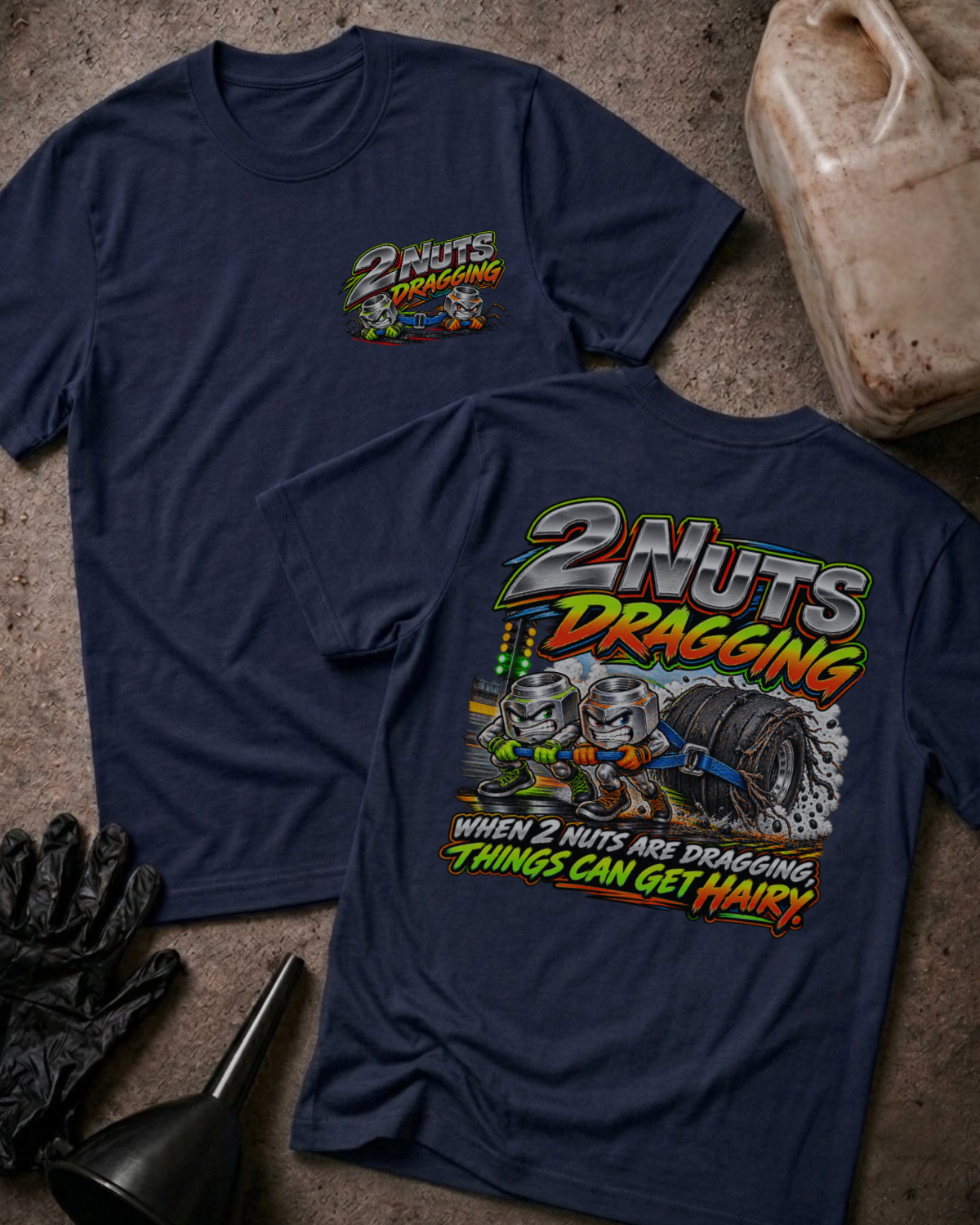 Navy 2 Nuts Dragging T-shirt, front and back views with cartoon nuts pulling a racing tire and the slogan “When 2 nuts are dragging, things can get hairy.”