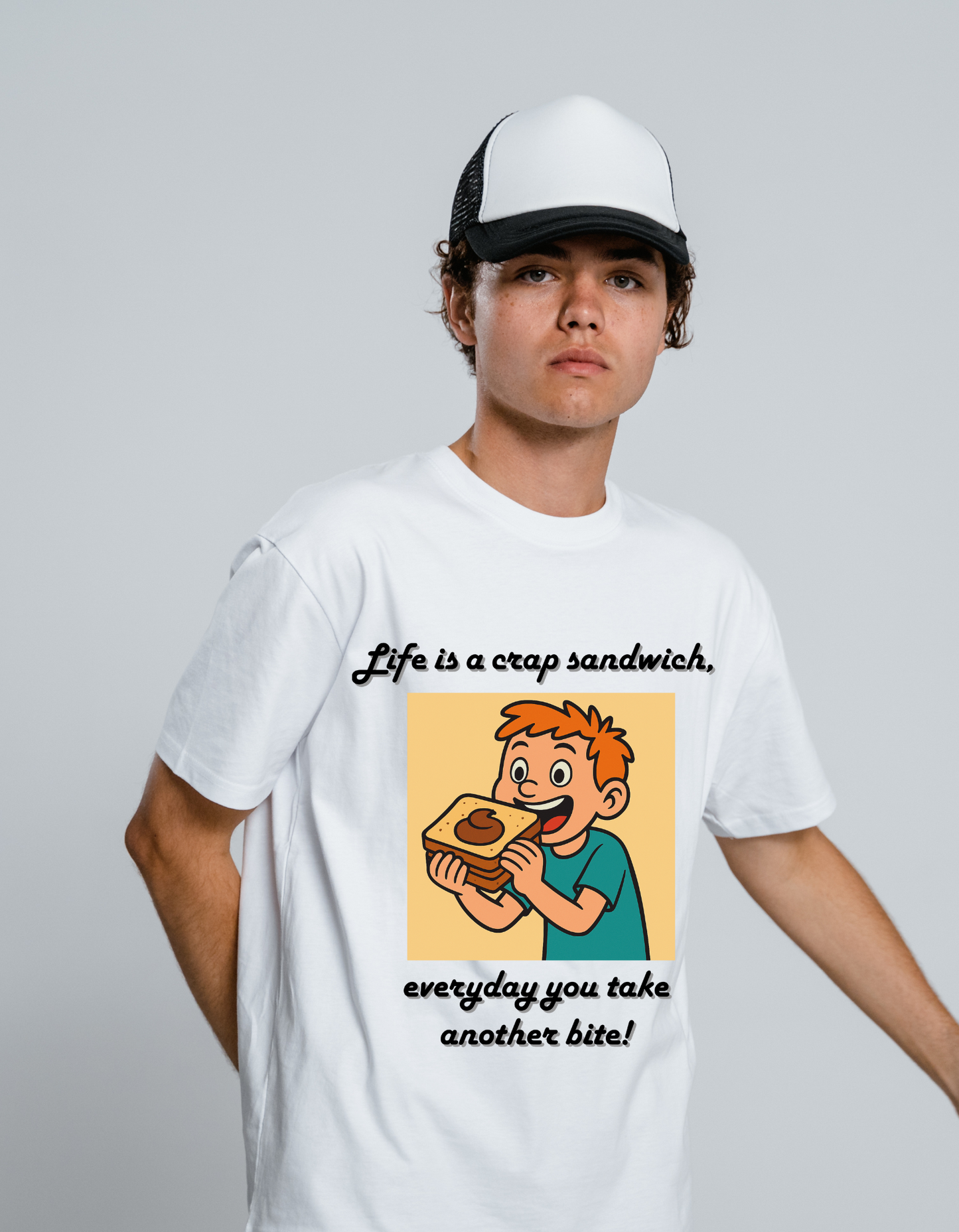 Person wearing a white t-shirt with a graphic of a boy eating a sandwich and text 'Life is a crap sandwich, everyday you take another bite!' on a white background