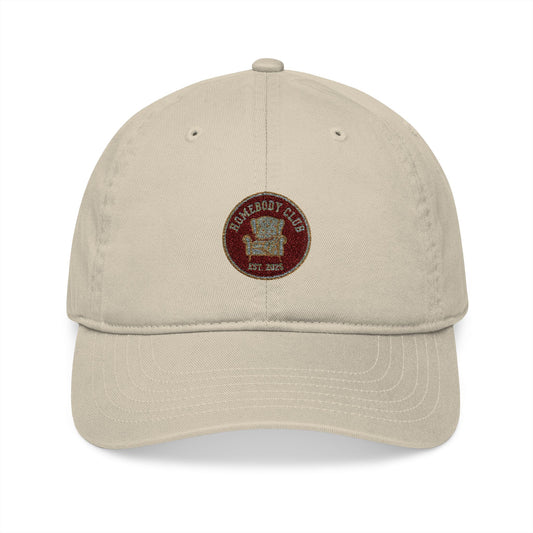 Beige cap with a red and brown logo and text 'Homebody club Est. 2025' on a white background