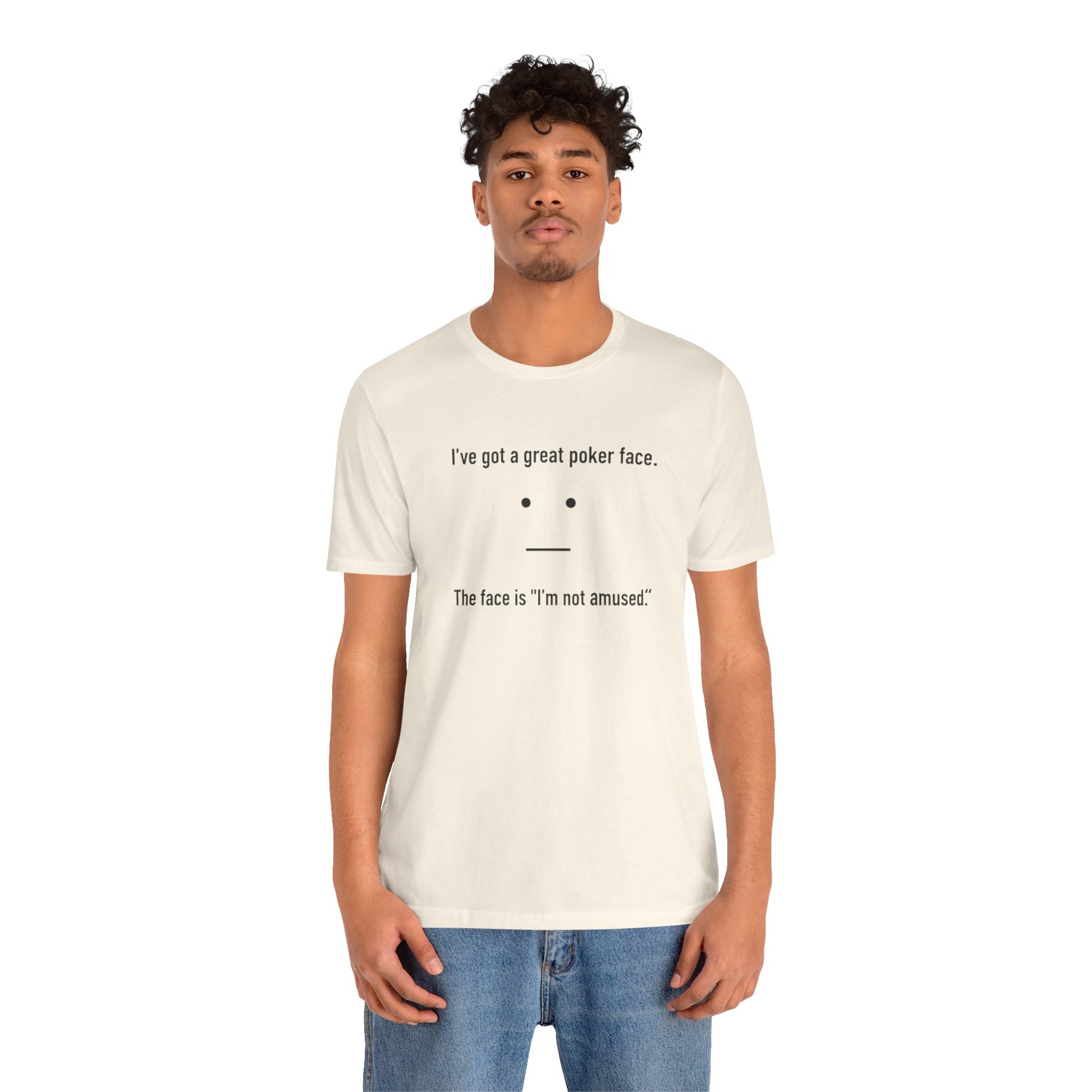 Person wearing a natural t-shirt with text 'I've got a great poker face. The face is I'm not amused.' and a face graphic on a white background