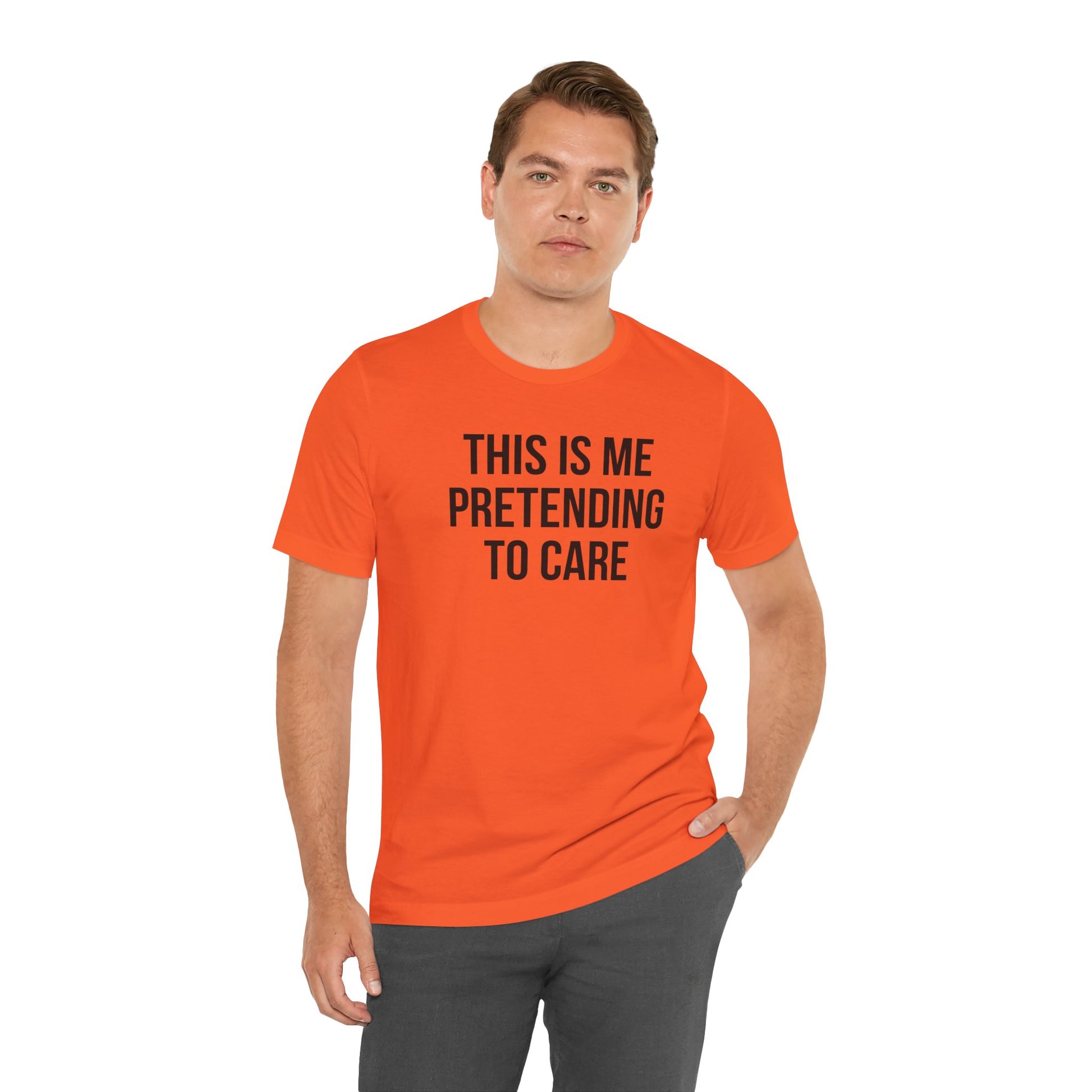Man wearing an orange t-shirt with text 'This is me pretending to care' on a white background
