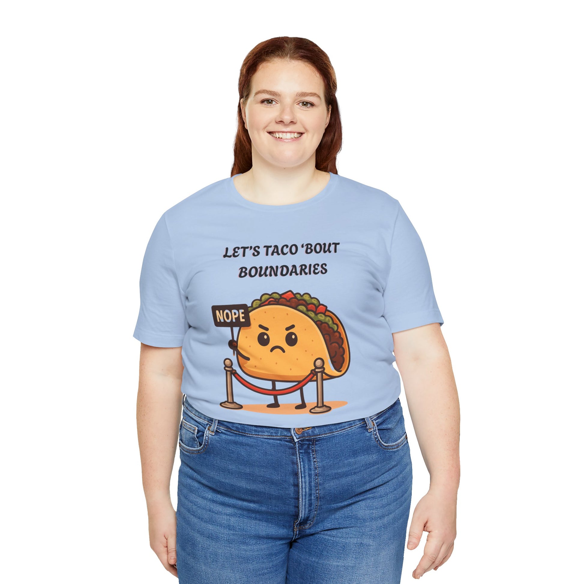 Person wearing a light blue t-shirt with a taco graphic and text 'Let's taco 'bout boundaries', on a white background