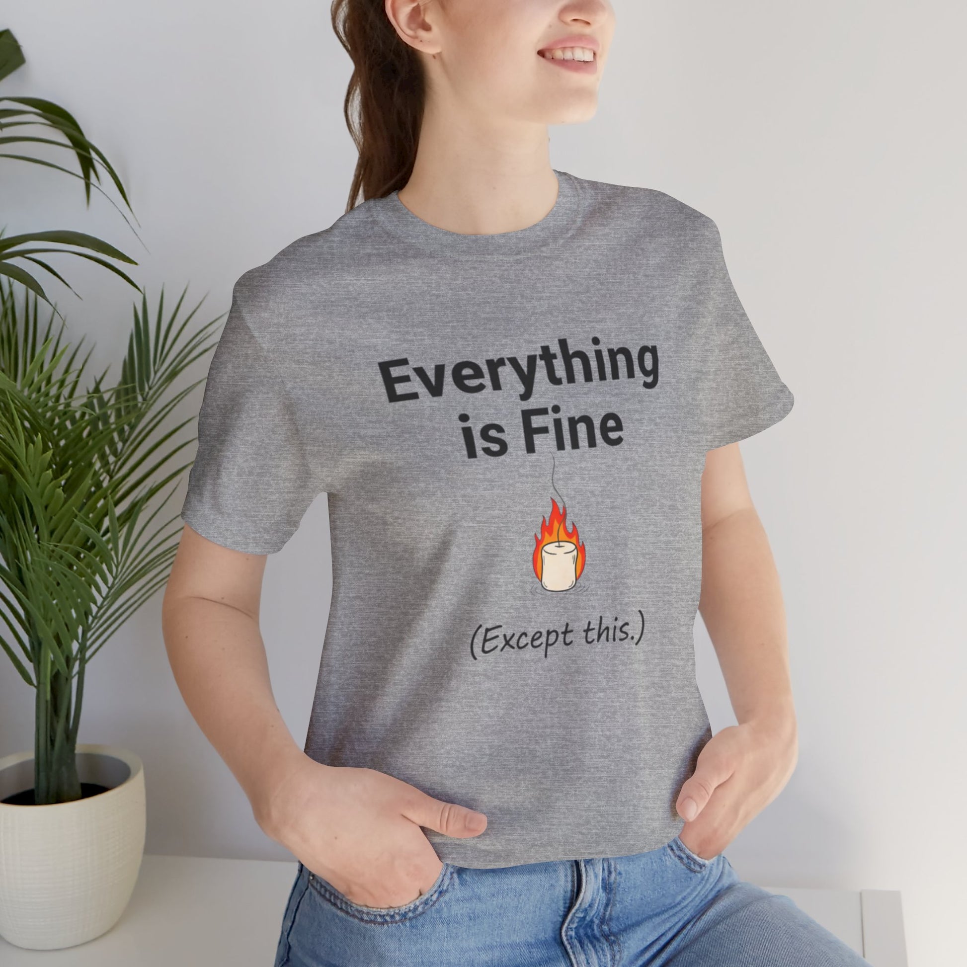 Person wearing a gray t-shirt with 'Everything is Fine (Except this)' text and a candle graphic.