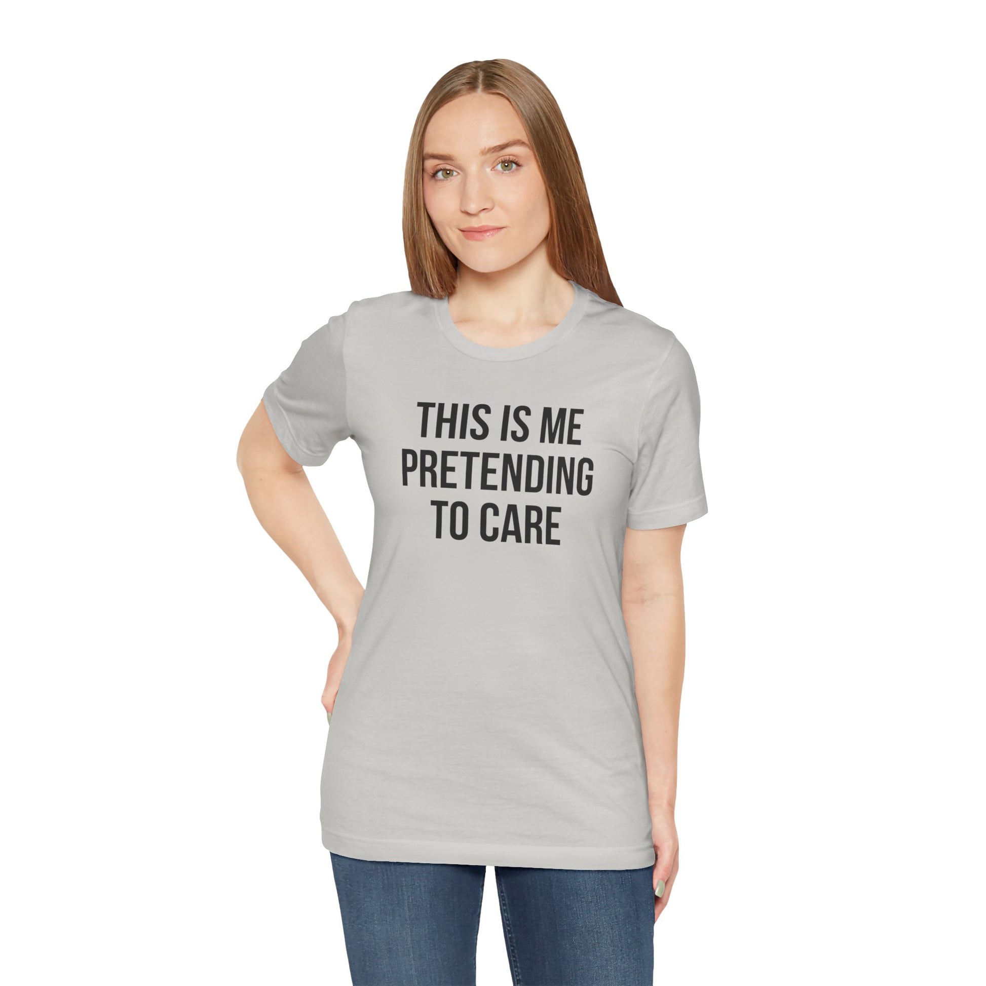 Woman wearing a gray t-shirt with text 'This is me pretending to care' on a white background