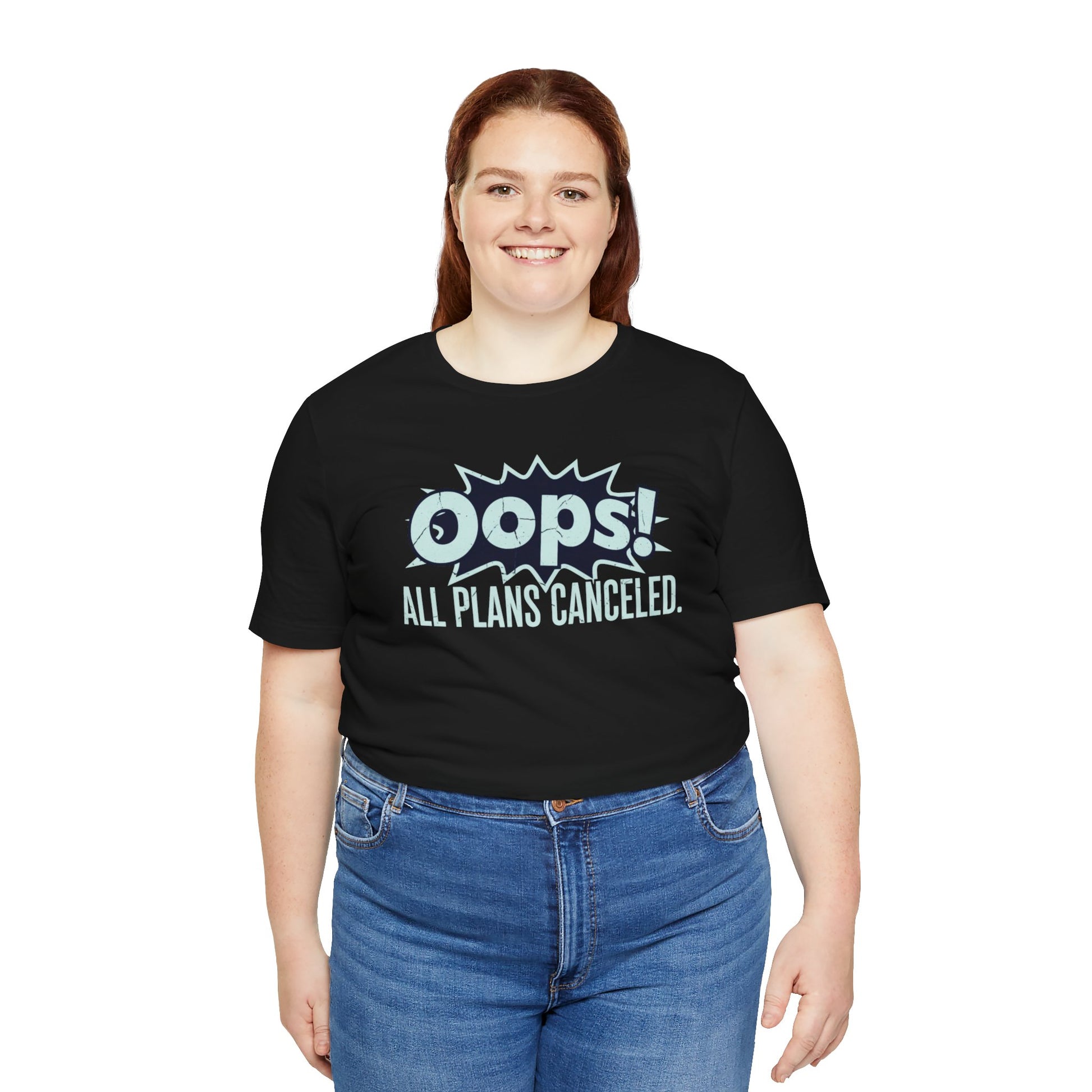 Person wearing a black t-shirt with 'Oops! All Plans Canceled' text on a white background