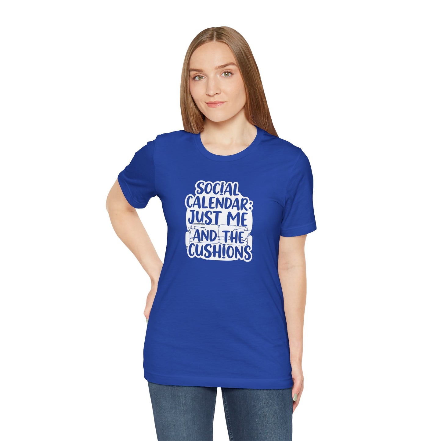 Person wearing a blue t-shirt with text 'Social calendar: Just me and the cushions' on a white background