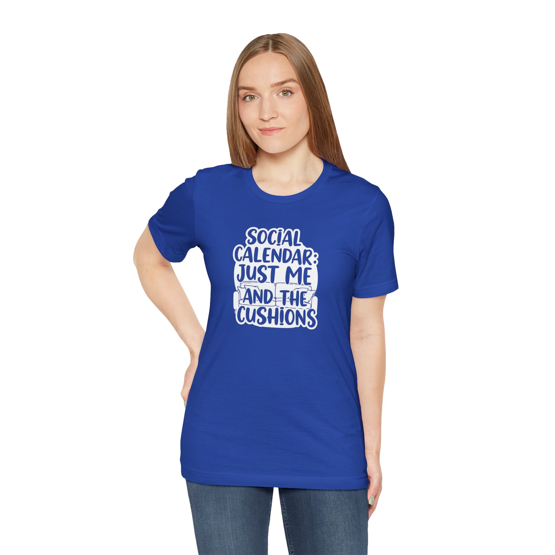 Person wearing a blue t-shirt with text 'Social calendar: Just me and the cushions' on a white background