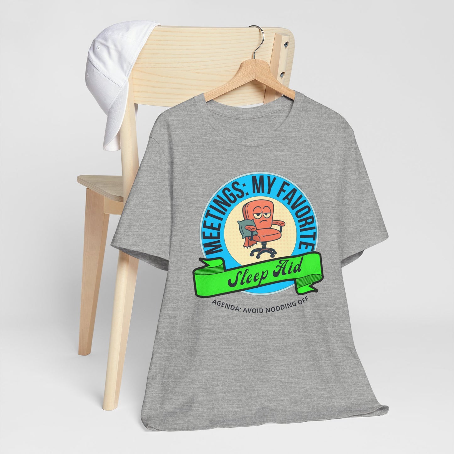 Gray t-shirt with a graphic design on a wooden chair against a white background
