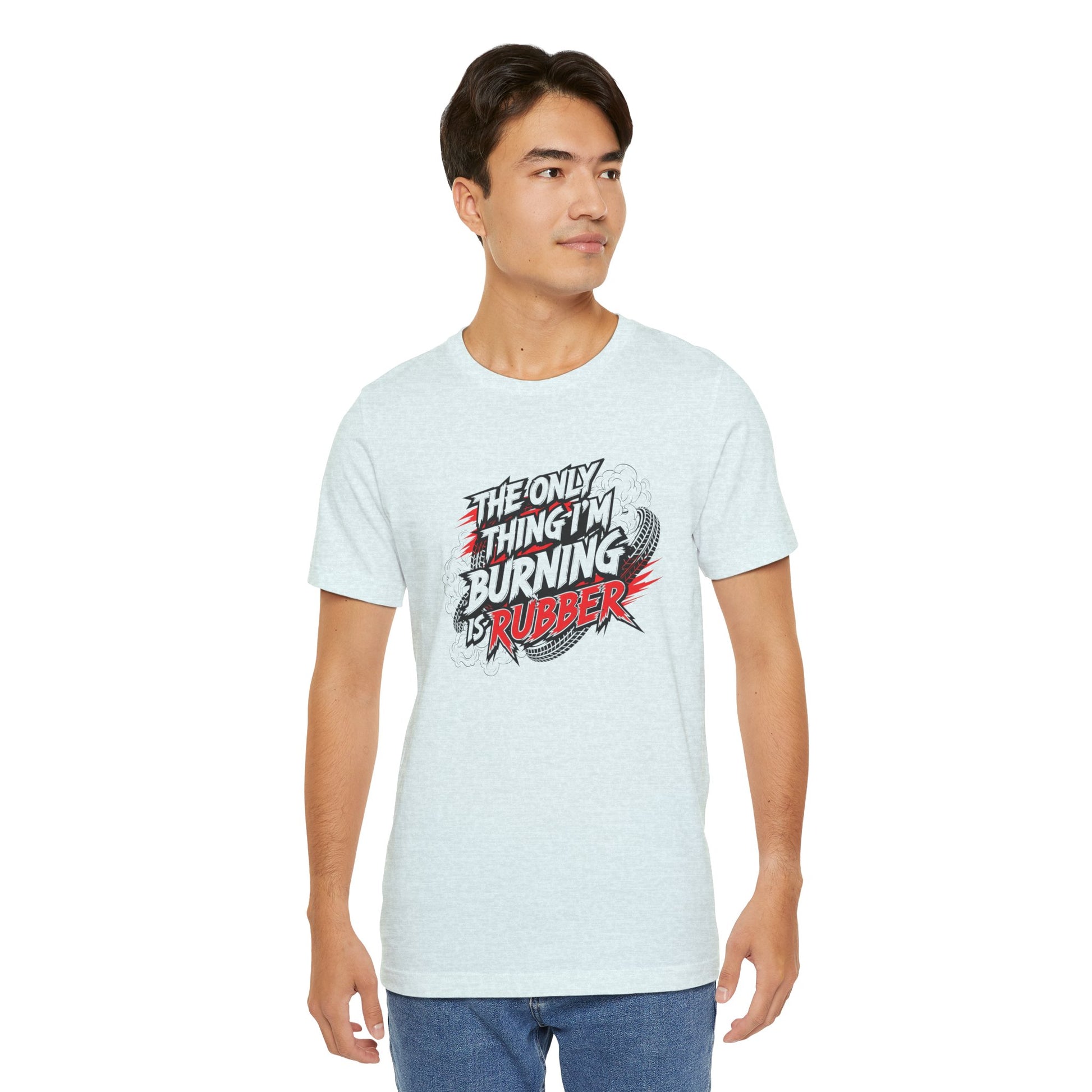 Man wearing a light blue t-shirt with a graphic design and text 'The only thing I'm burning is rubber' on a white background