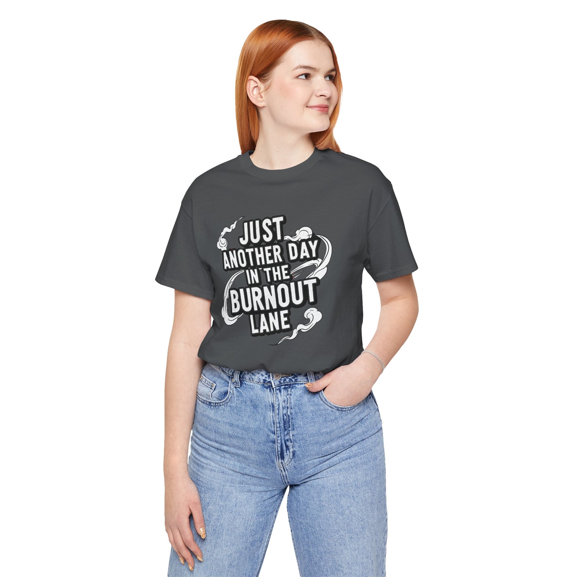 Person wearing a dark gray t-shirt with text and light blue jeans on a white background