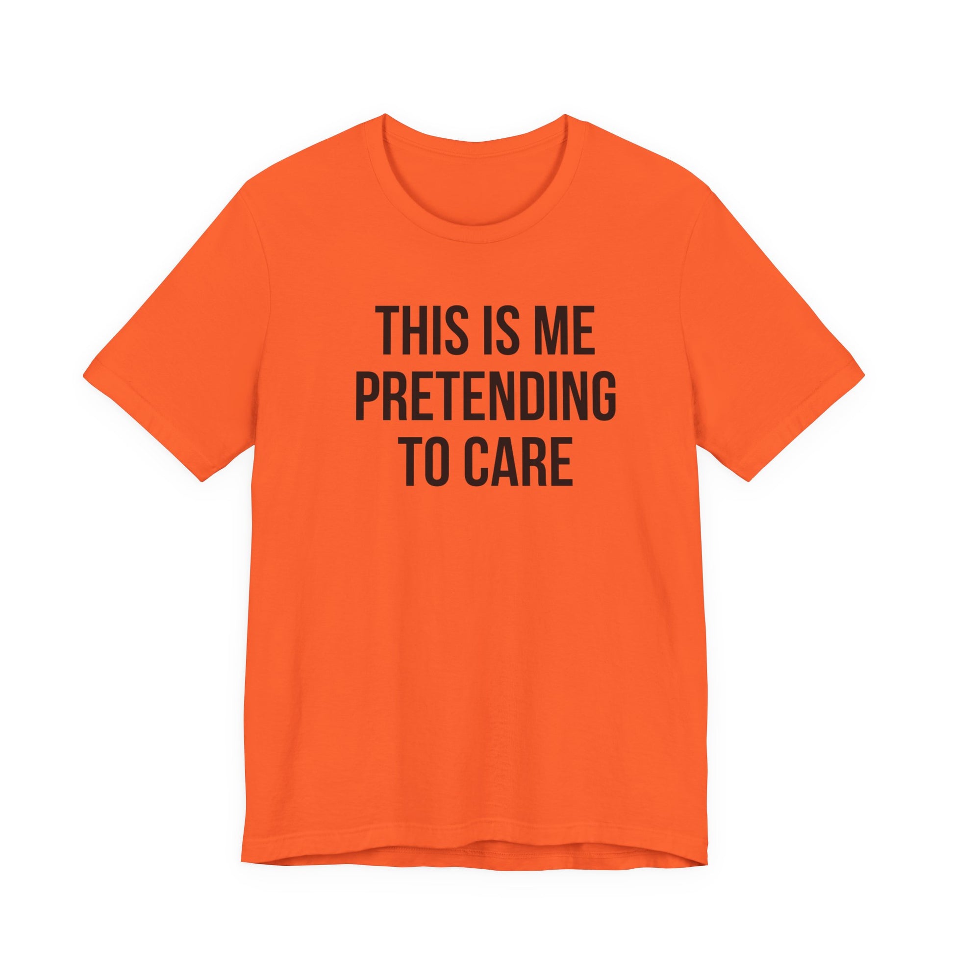 Orange t-shirt with black text 'THIS IS ME PRETENDING TO CARE' on a white background