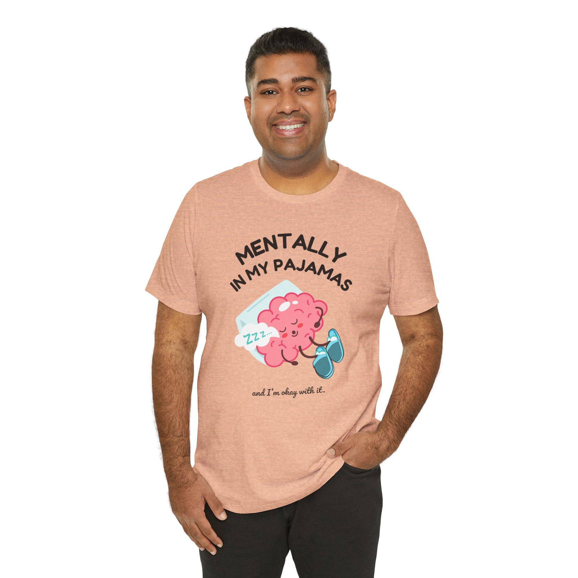 Man wearing a pink t-shirt with a cartoon character and text 'Mentally in my pajamas and I'm ok with it' on a white background