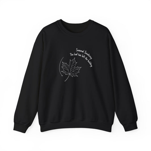Black sweatshirt with a white leaf design and text 'Seasonal Socializing, The leaf has left the building' on a white background