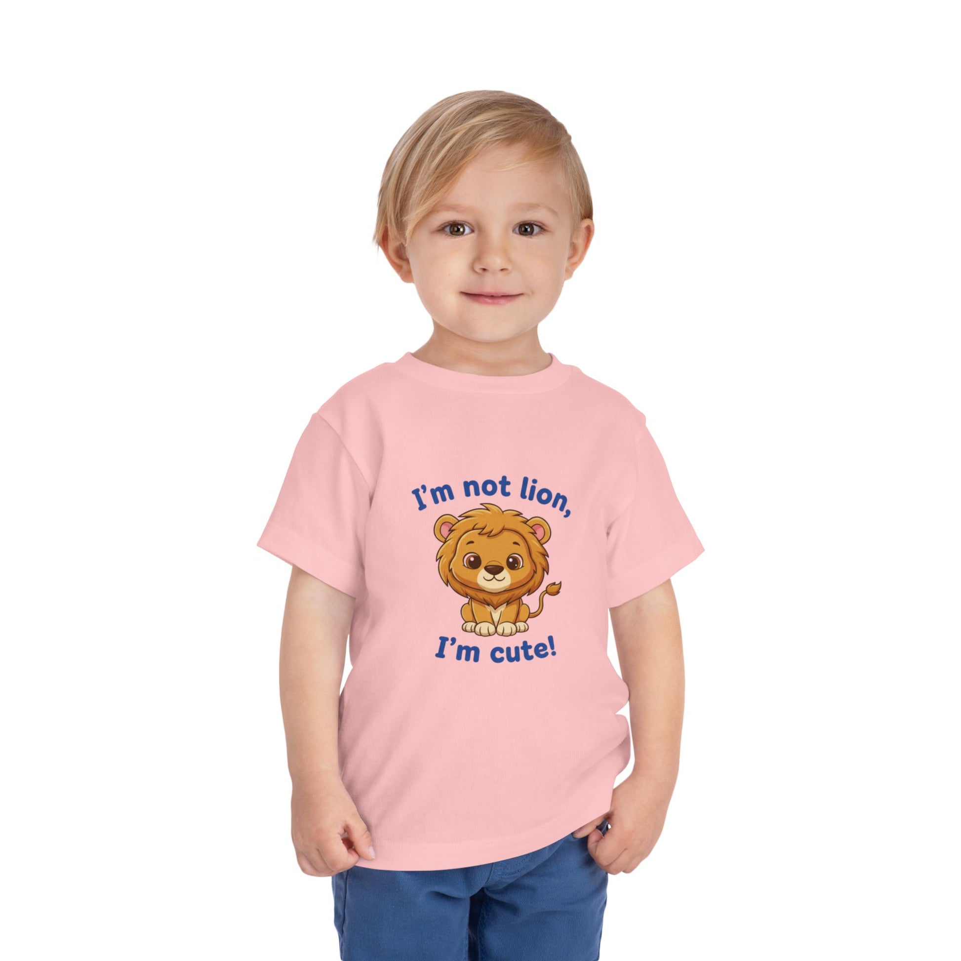 Child wearing a pink t-shirt with a lion graphic and text "I'm Not Lion I'm Cute"  Bella+Canvas 3001T on a white background