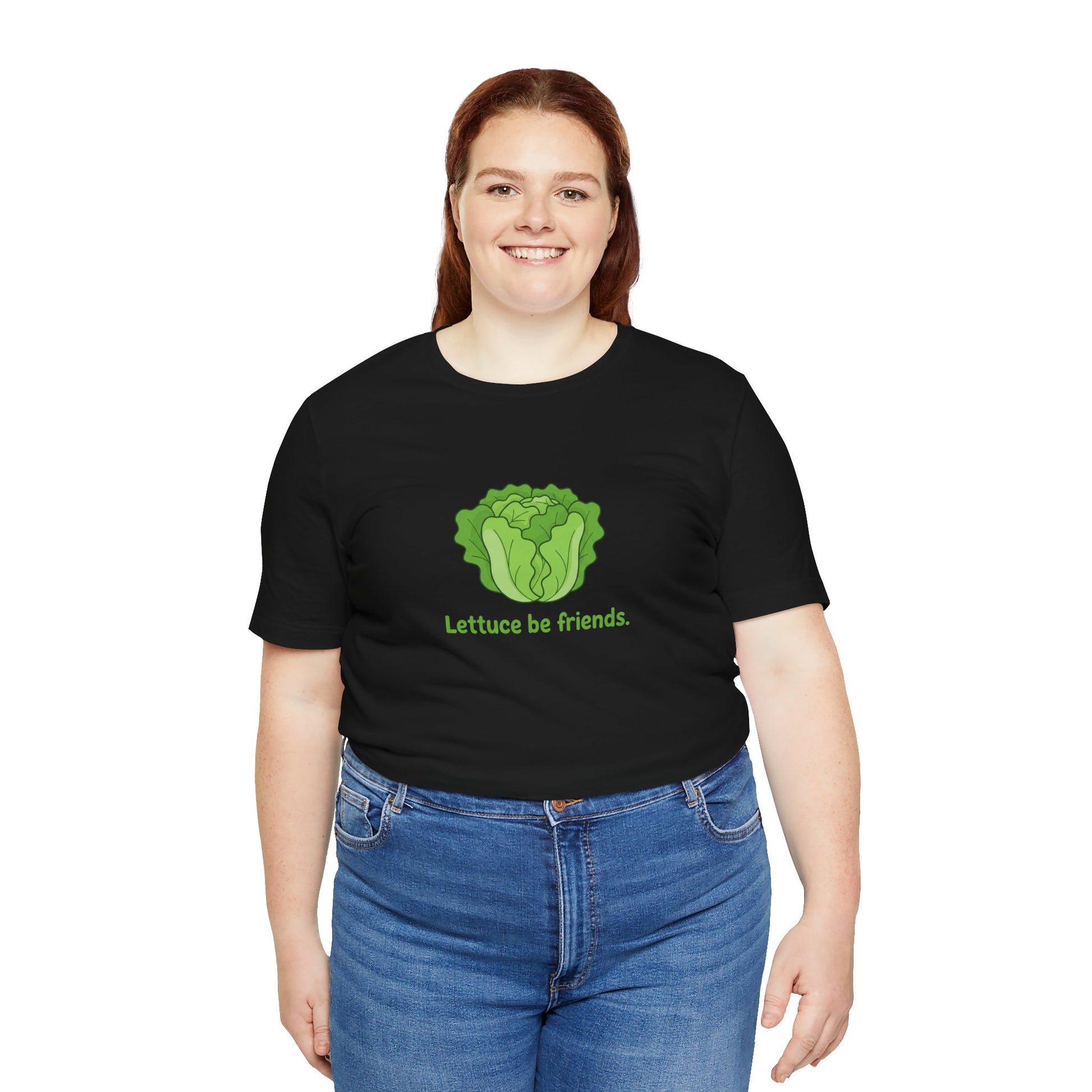 Person wearing a black t-shirt with a green graphic and text 'Lettuce be friends' on a white background