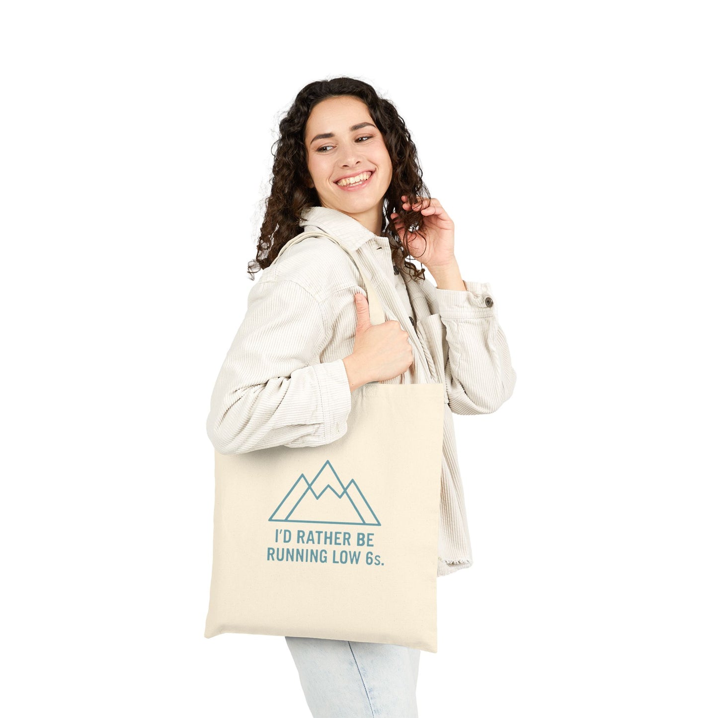 Woman holding a tote bag with text 'I'd rather be running low 6s' and graphics on a white background
