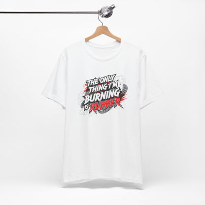 White t-shirt with graphic design and text 'The only thing I'm burning is rubber' on a white background