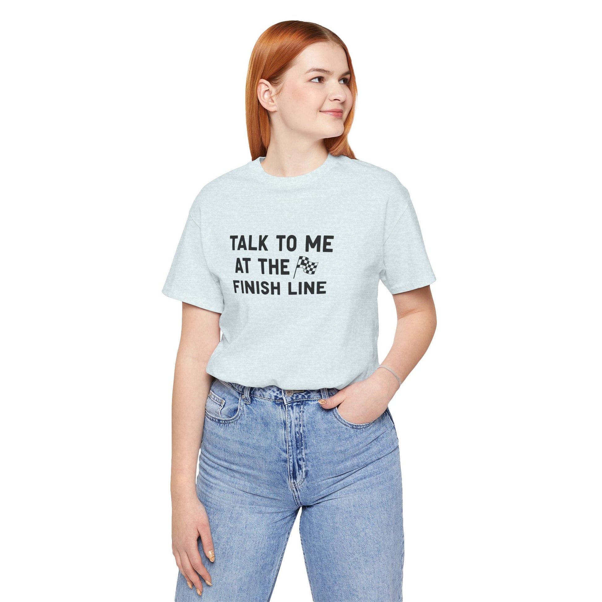 Person wearing a light blue t-shirt with text 'Talk to me at the finish line' on a white background