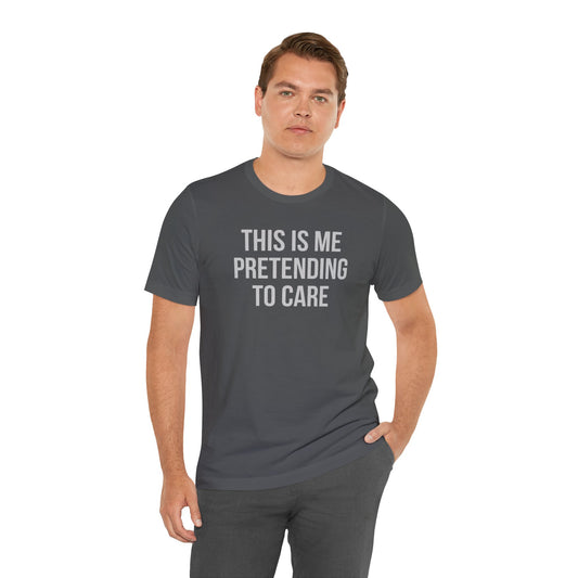Man wearing a gray t-shirt with text 'THIS IS ME PRETENDING TO CARE' on a white background