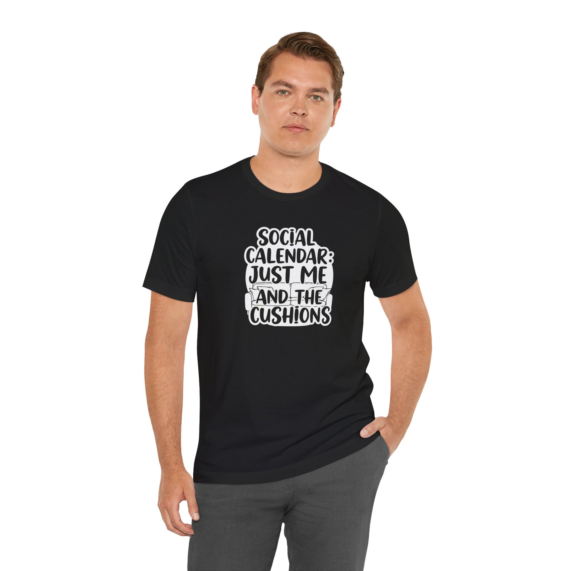 Man wearing a black t-shirt with text 'Social calendar: Just me and the cushions' on a white background