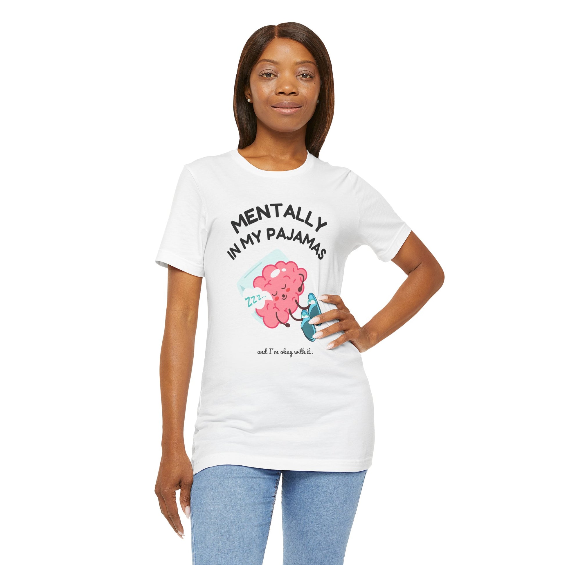 Woman wearing a white t-shirt with a graphic and text 'Mentally in my pajamas and I'm ok with it', standing against a white background