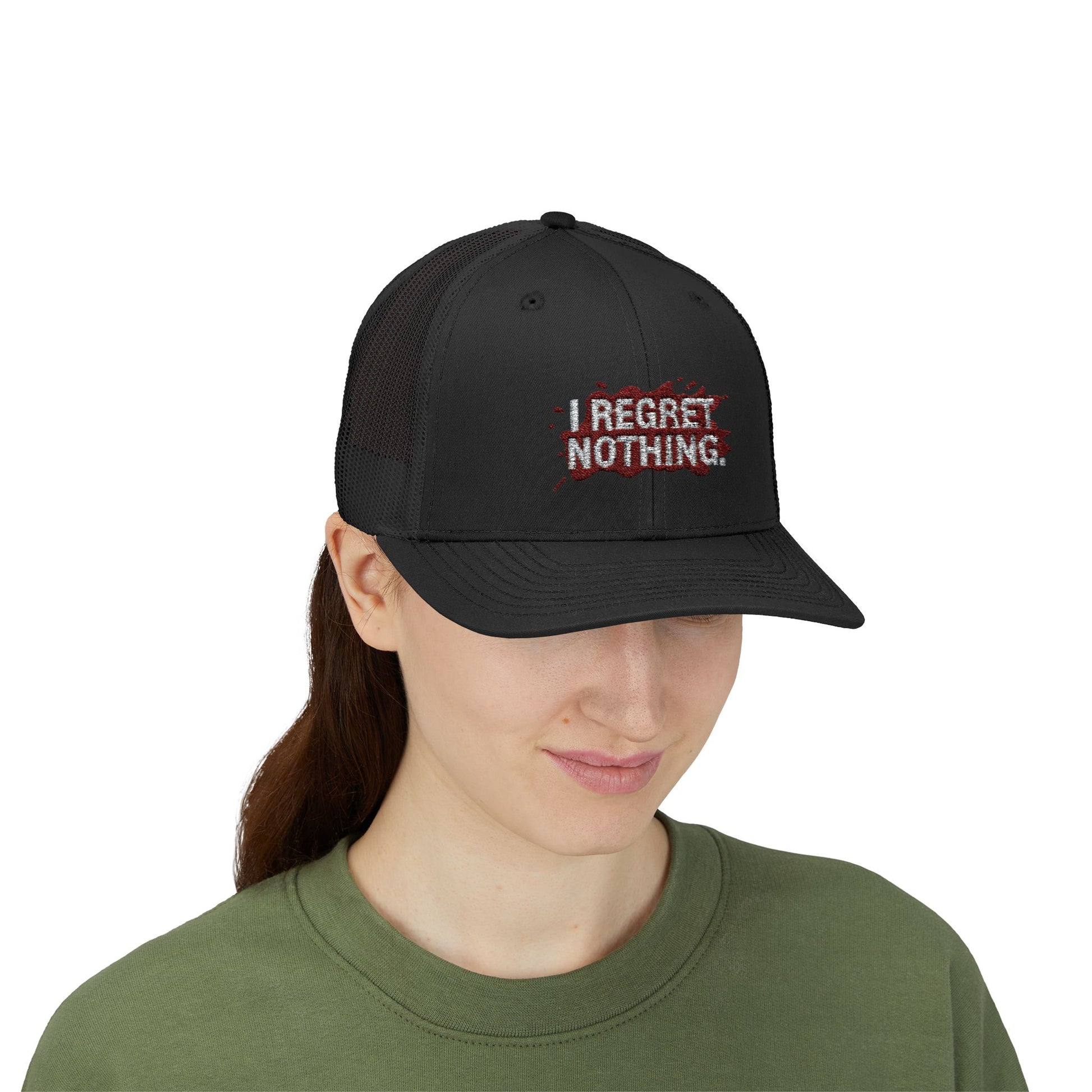 Person wearing a black cap with 'I Regret Nothing' text on a white background