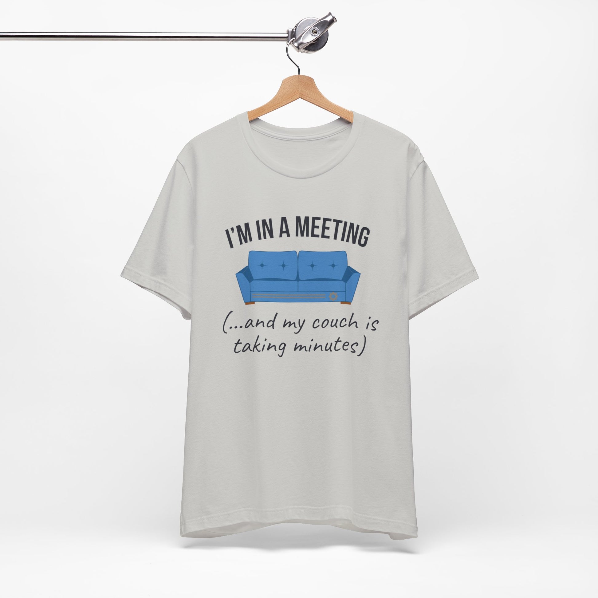 Gray t-shirt with a graphic and text 'I'm in a meeting (...and my couch is taking minutes)' on a white background