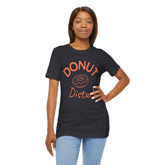 Woman wearing a black t-shirt with 'Donut Disturb' text and donut graphic on a white background