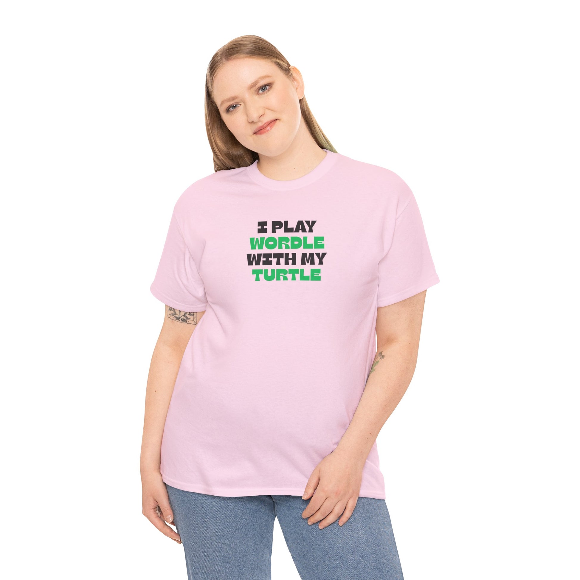 Person wearing a pink t-shirt with text 'I play wordle with my turtle' on a white background