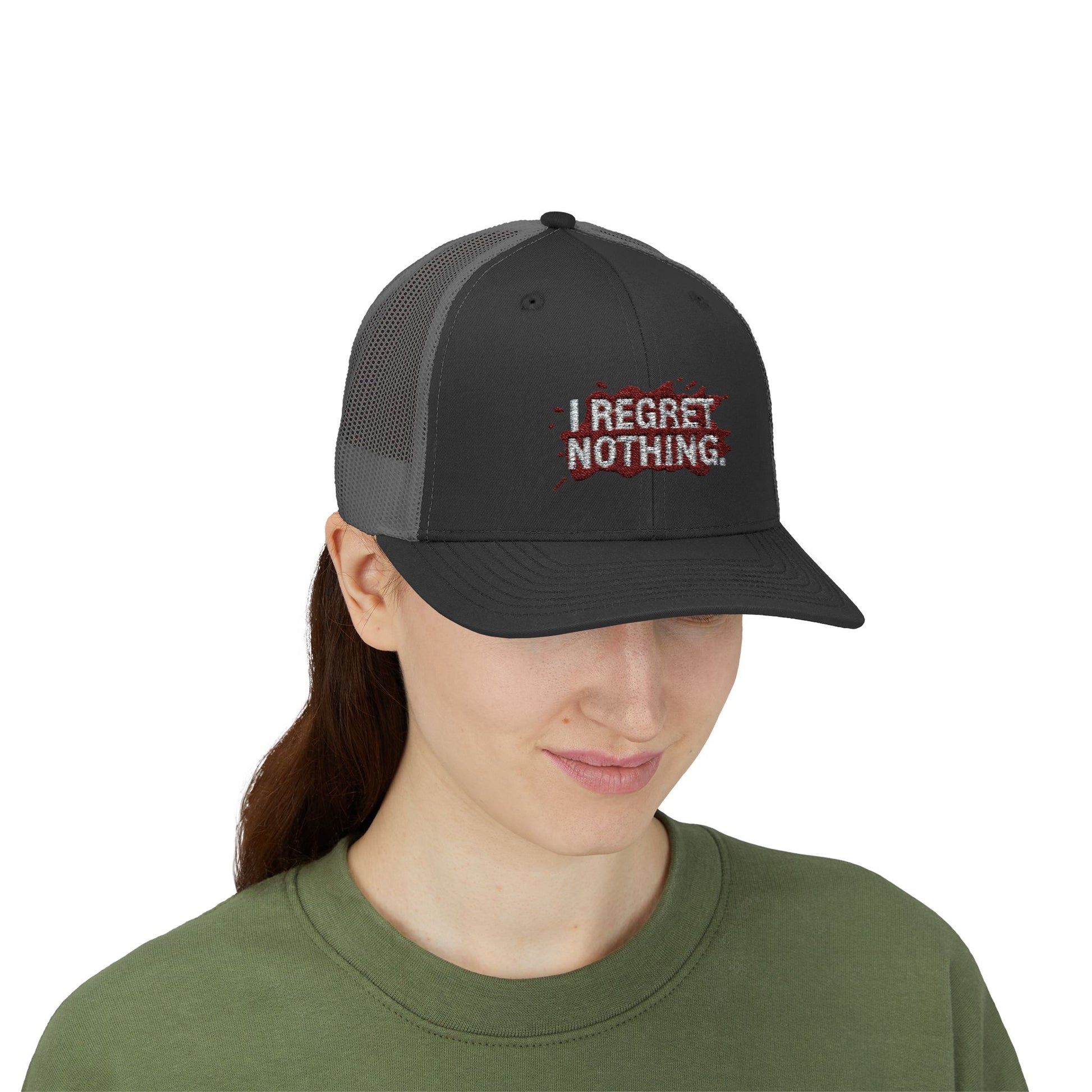 Person wearing a black cap with 'I Regret Nothing' text on a white background