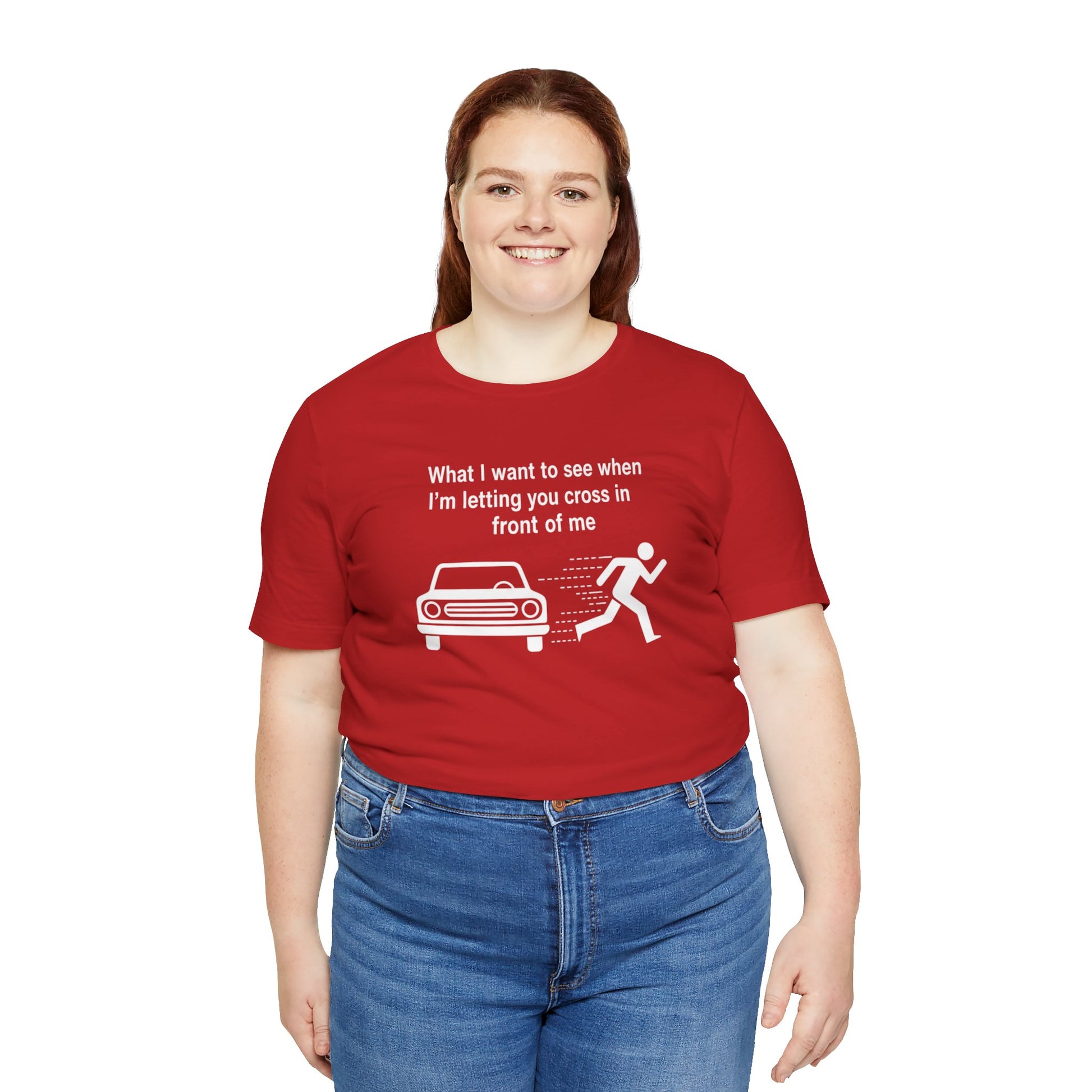 Person wearing a red t-shirt with a humorous graphic and text 'What I want to see when I'm letting you cross in front of me' on a white background