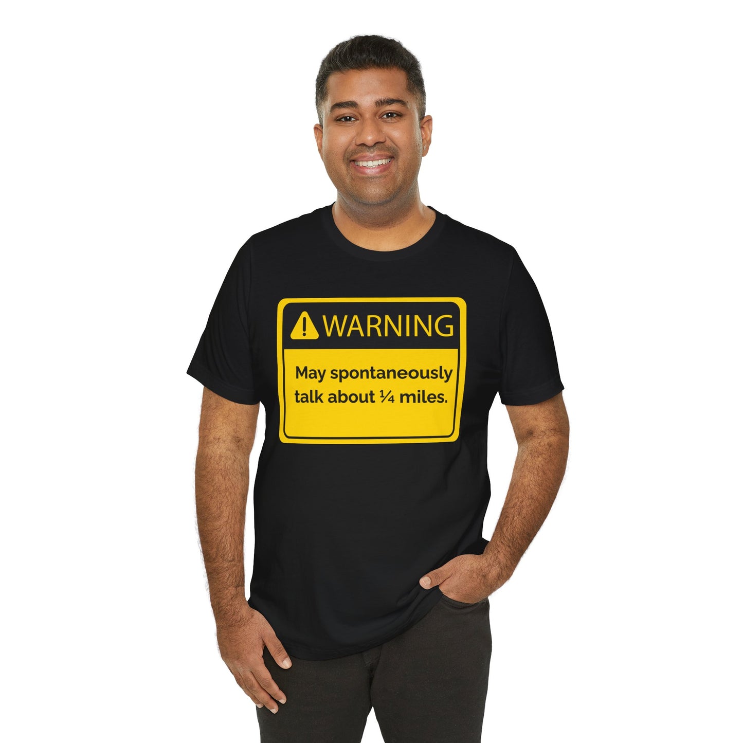 Man wearing a black t-shirt with a yellow warning sign 'WARNING May spontaneously talk about 1/4 miles' graphic on a white background