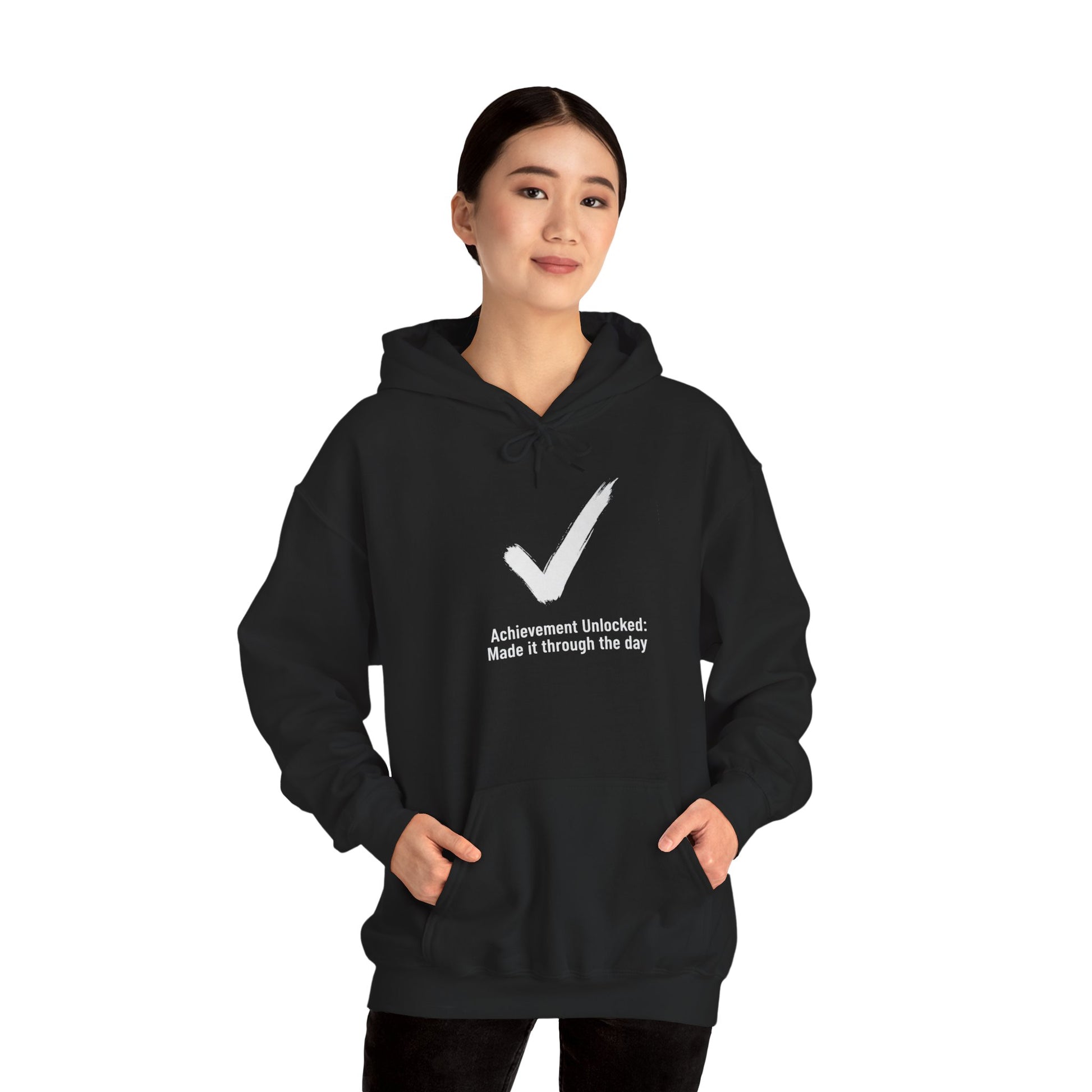 Person wearing a black hoodie with a white checkmark and text 'Achievement Unlocked: Made it through the day' on a white background