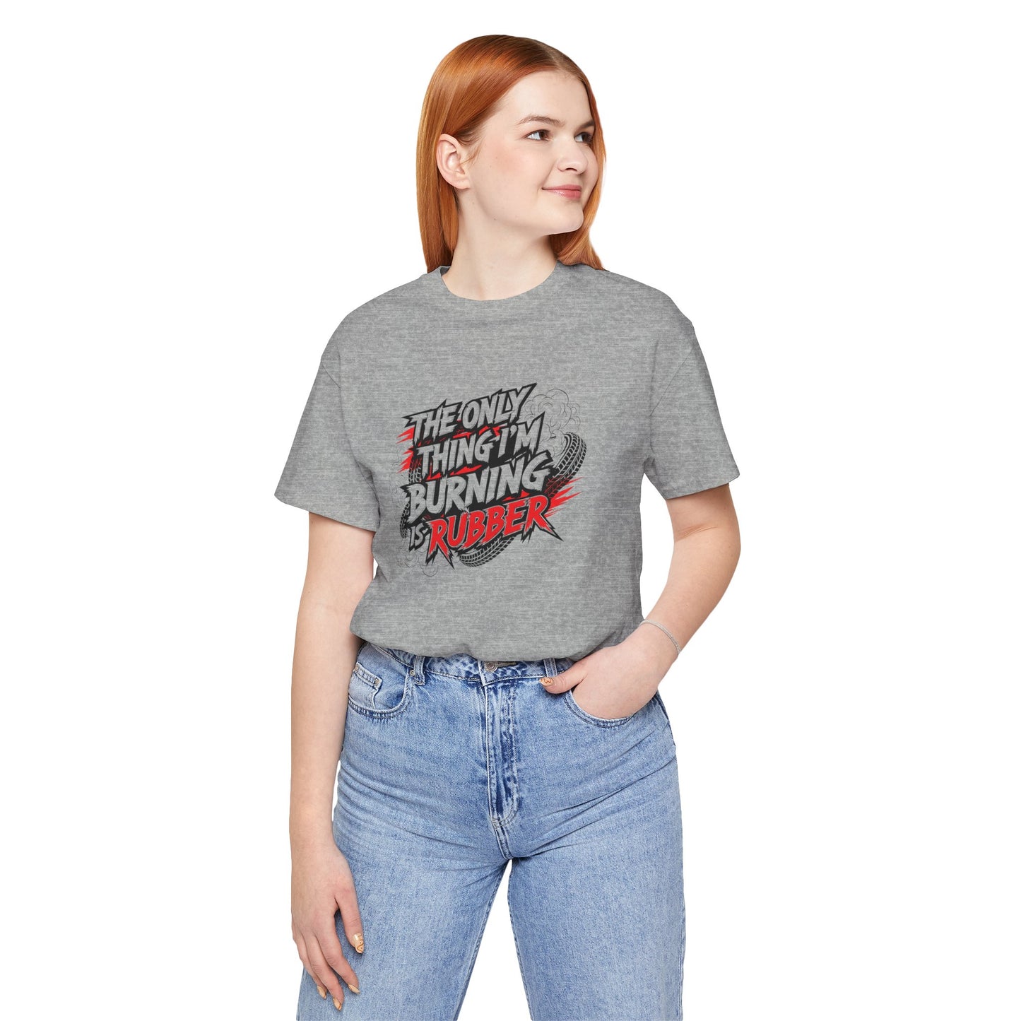Person wearing a gray t-shirt with a graphic design and text 'The only thing I'm burning is rubber' on a white background