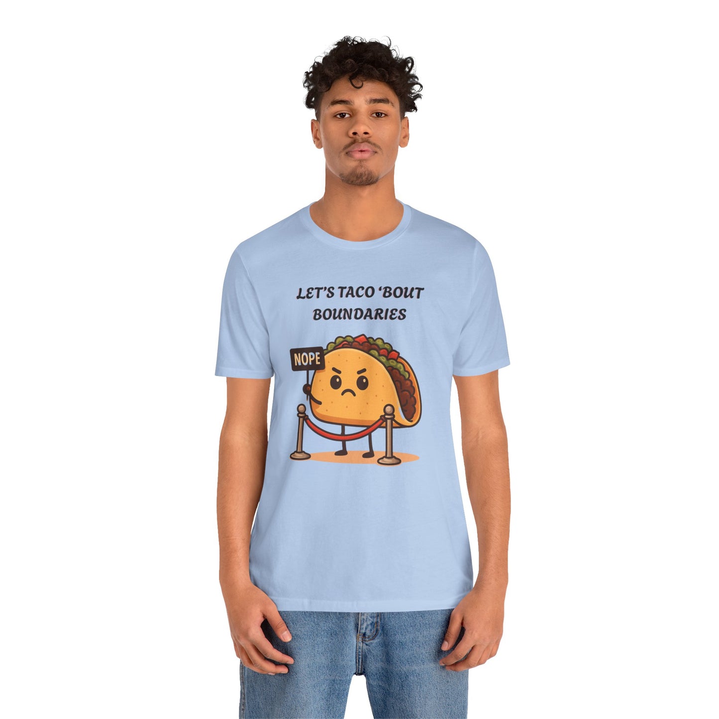 Person wearing a light blue t-shirt with a taco graphic and text 'Let's taco 'bout boundaries', on a white background