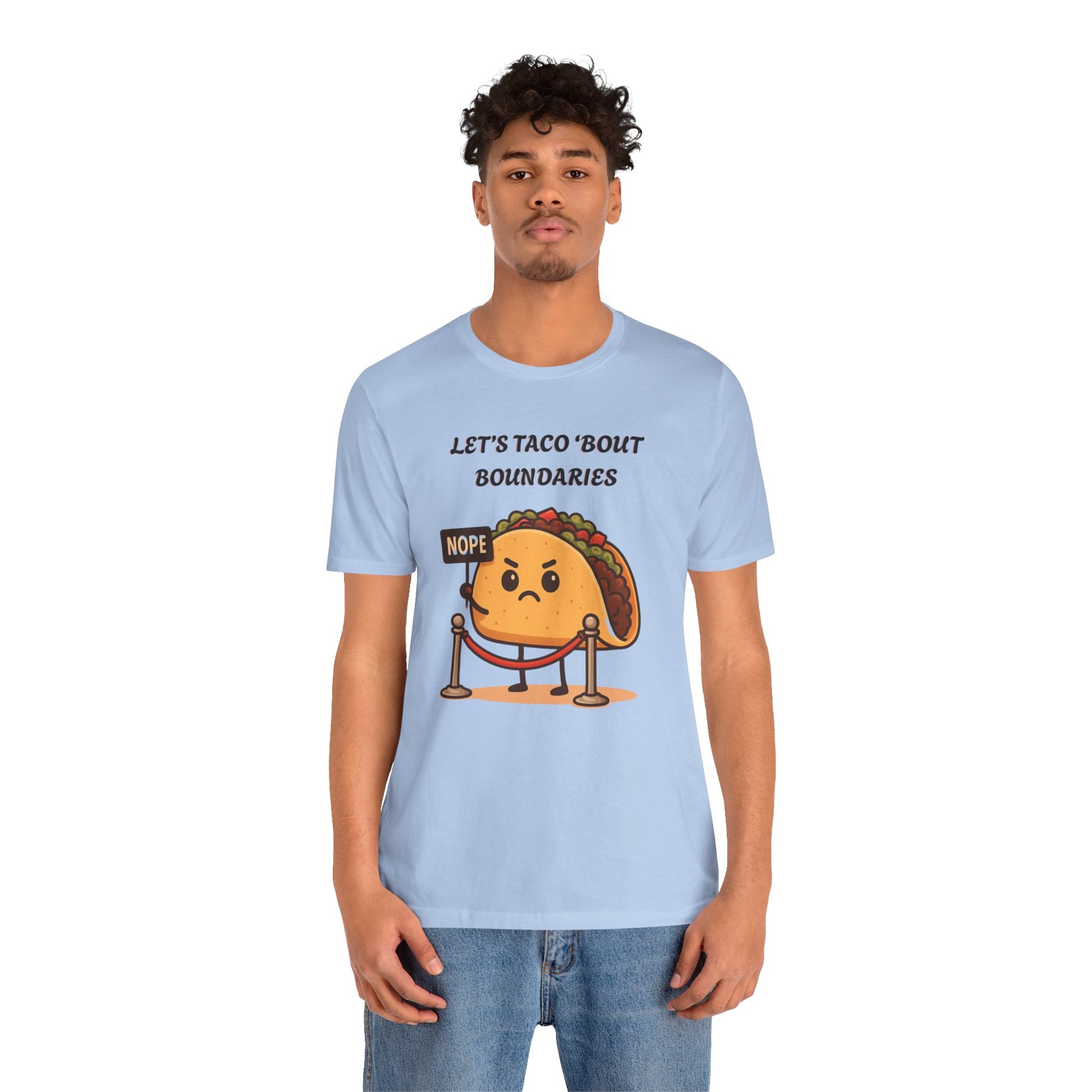 Person wearing a light blue t-shirt with a taco graphic and text 'Let's taco 'bout boundaries', on a white background