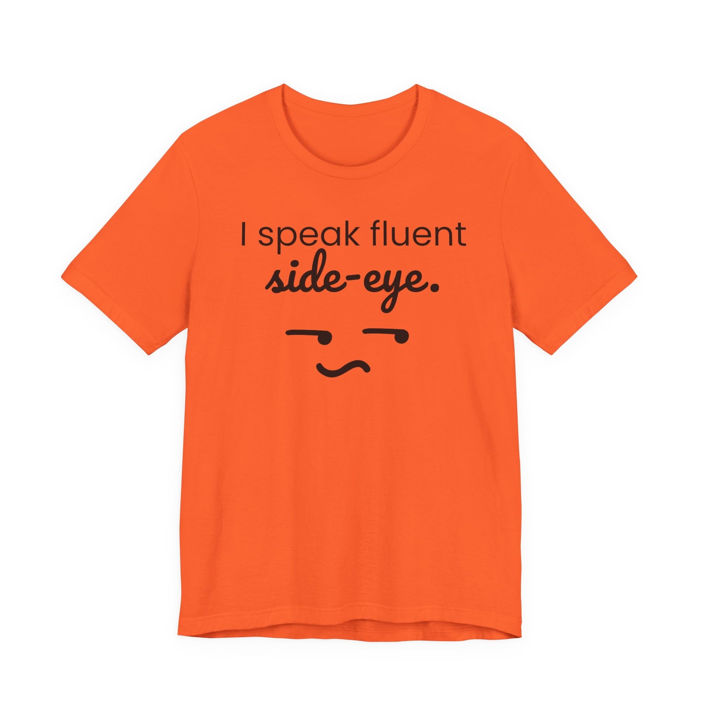 Orange t-shirt with black text 'I speak fluent side eye' and a face graphic on a white background