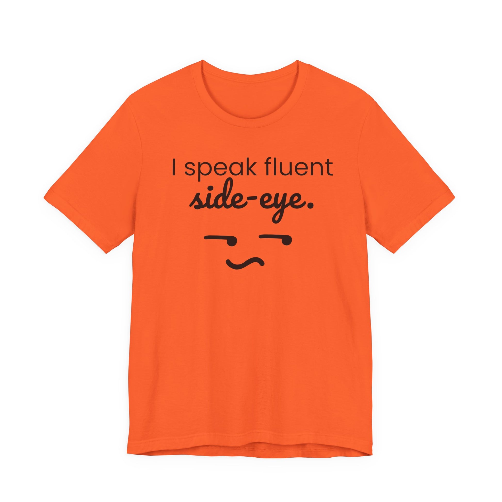 Orange t-shirt with black text 'I speak fluent side eye' and a face graphic on a white background